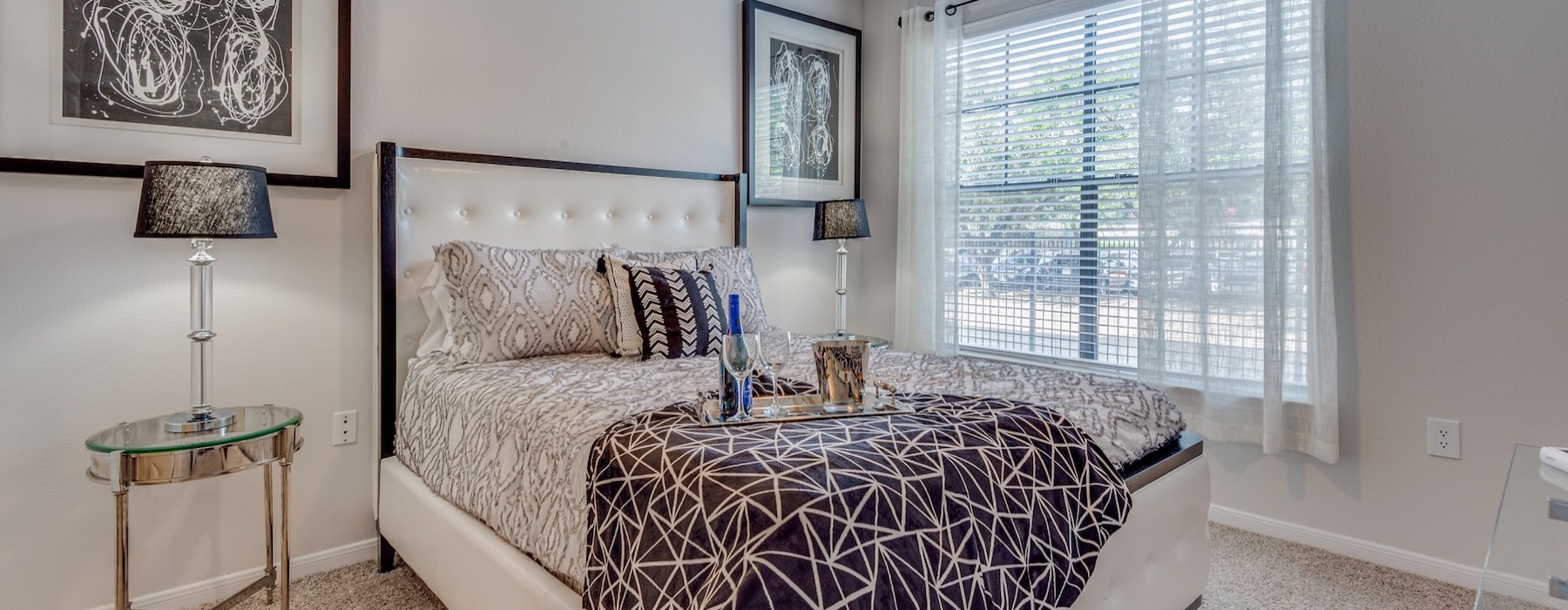 a bedroom with a large bed and a fan