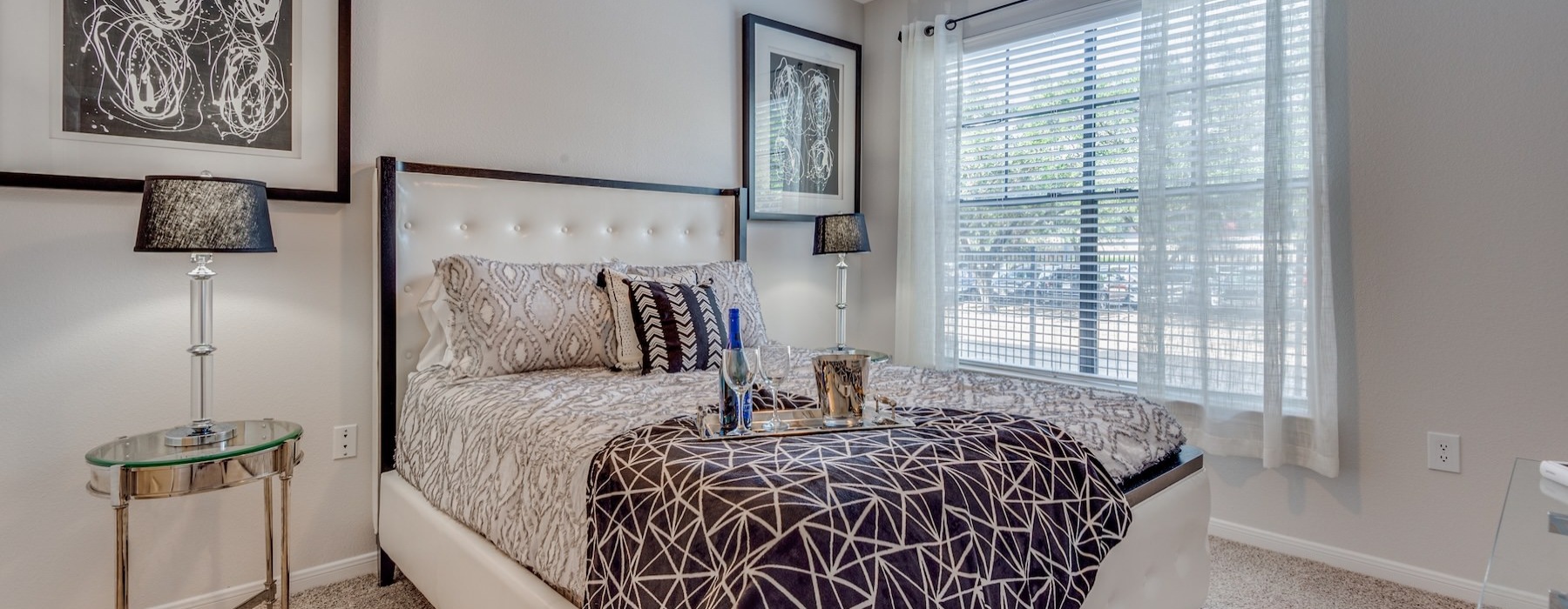 a bedroom with a large bed and a fan