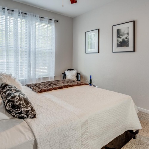 a bedroom with a bed and a fan