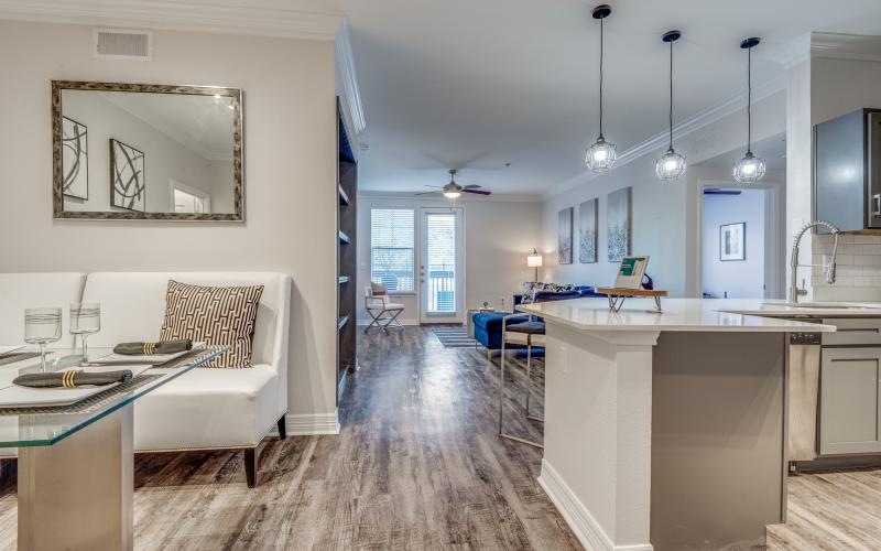 a dining booth area with a kitchen and a living room