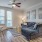 a living room with a couch and a fan