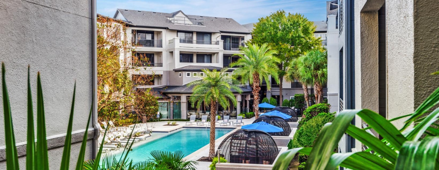 a building with a pool and trees